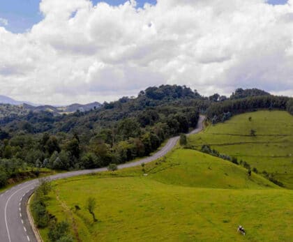 Winding countryside road through green hills in western Rwanda