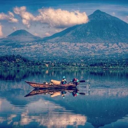 Small wooden boats moored along Lake Kivu at sunset