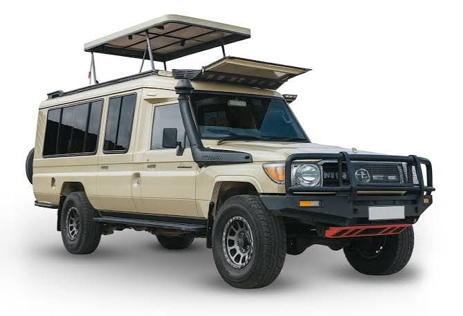 Beige Toyota Land Cruiser safari vehicle with roof hatches