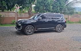 Black Toyota Land Cruiser parked on a Rwandan road