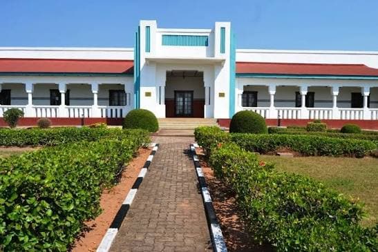 Historic red-roofed building with formal gardens in Rwanda