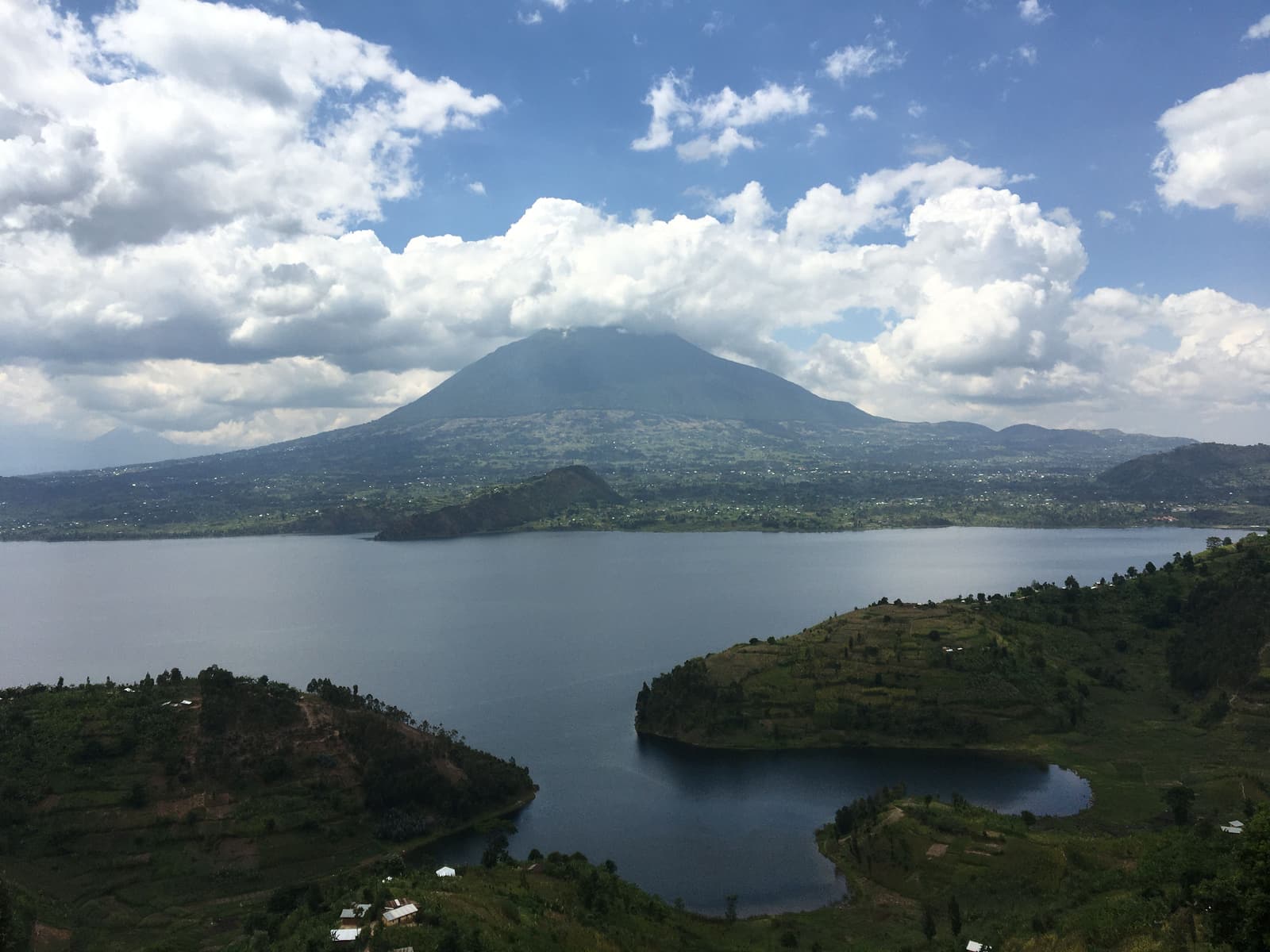 Lake with a volcano rising behind in northern Rwanda
