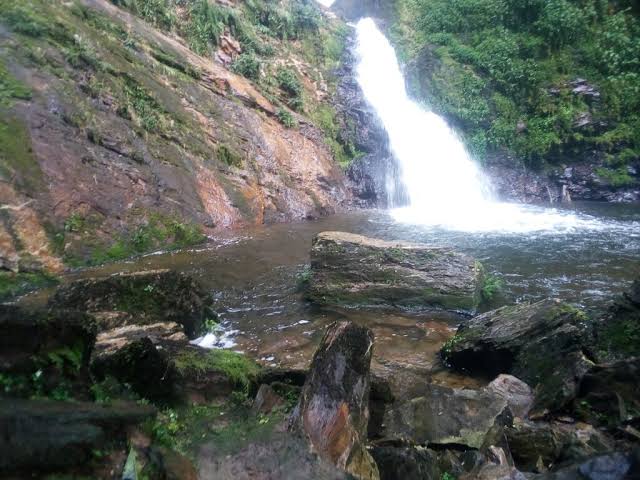Isumo waterfall cascading into a rocky pool in Nyungwe National Park